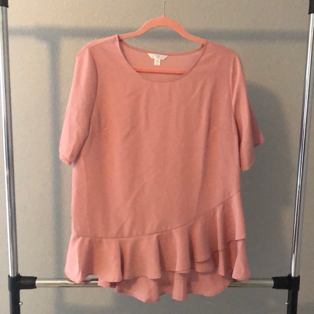 Pink short sleeve ruffled bottom blouse.